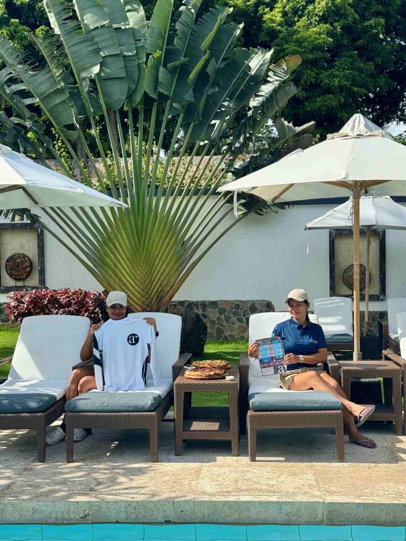 Housekeeping team enjoying the sun and pizza by the pool