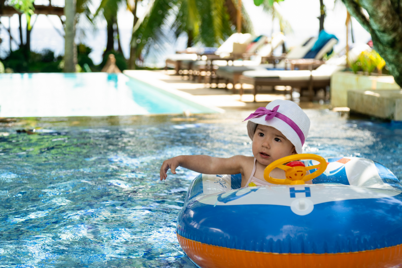 Baby in a float ring enjoying the family pool at Atmosphere Resorts & Spa in Dauin