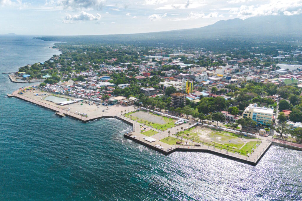 Aerial view of Rizal Boulevard and Dumaguete City coastline with Mount Talinis in the background, Negros Oriental, Philippines.