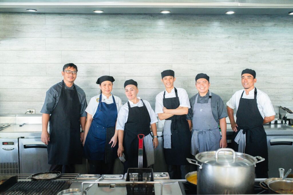 Atmosphere Resorts & Spa chefs and kitchen staff standing together in a professional kitchen