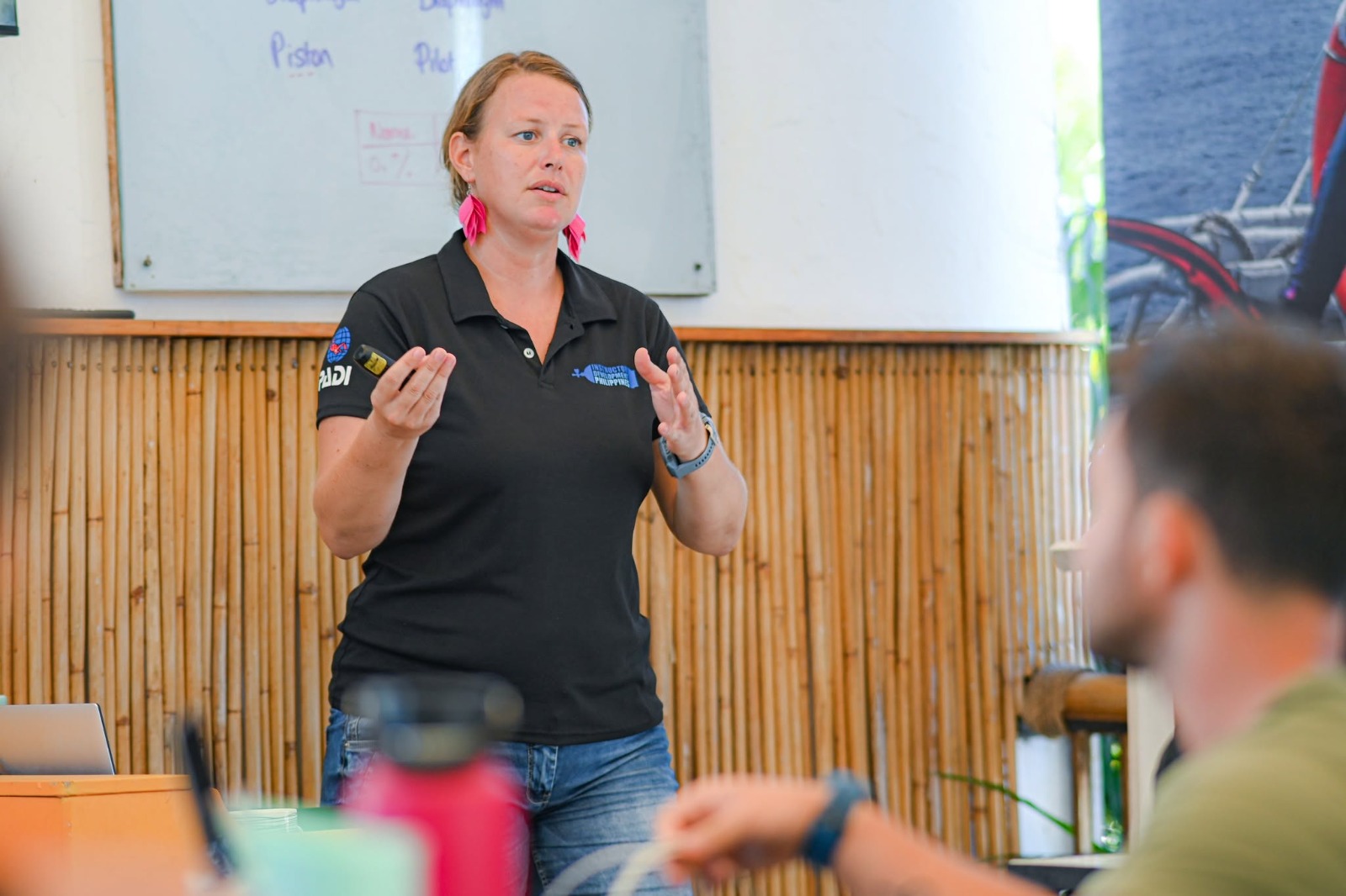 PADI Course Director Berlinda teaching IDC students in a classroom at Atmosphere Resorts & Spa