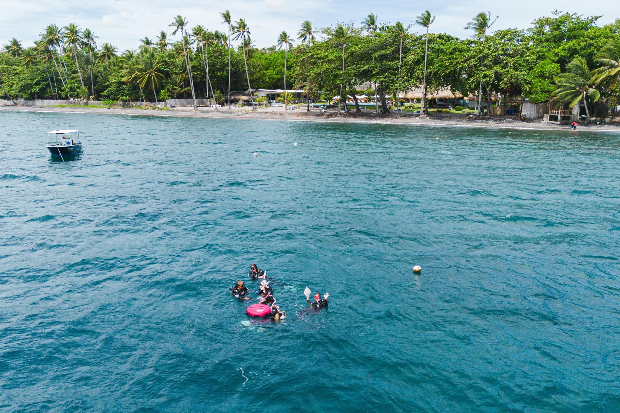PADI Instructor Development Course students practising scuba skills in the ocean off Atmosphere Resorts & Spa in Dauin