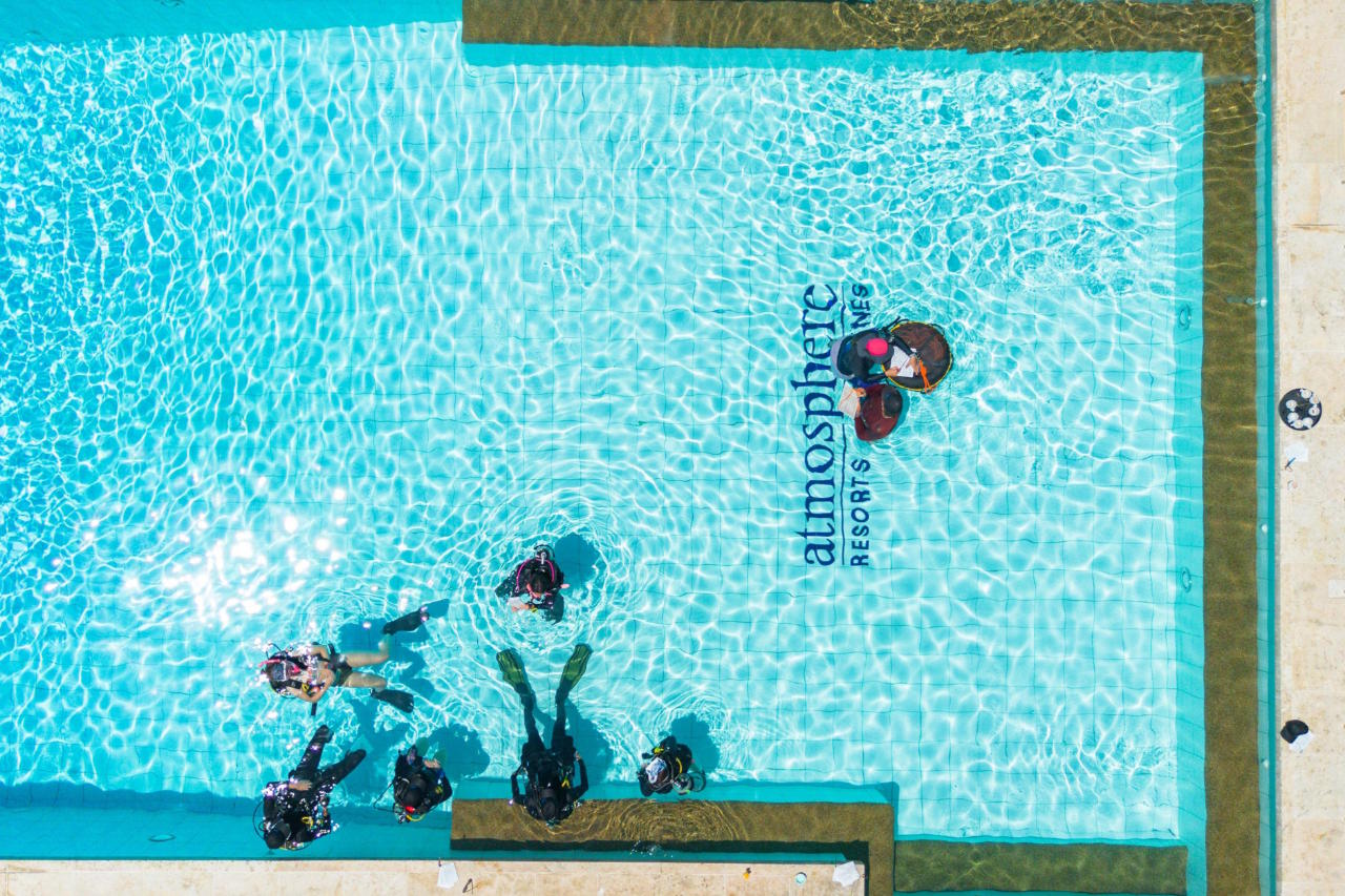 PADI Instructor Development Course students practicing scuba skills in the pool at Atmosphere Resorts & Spa