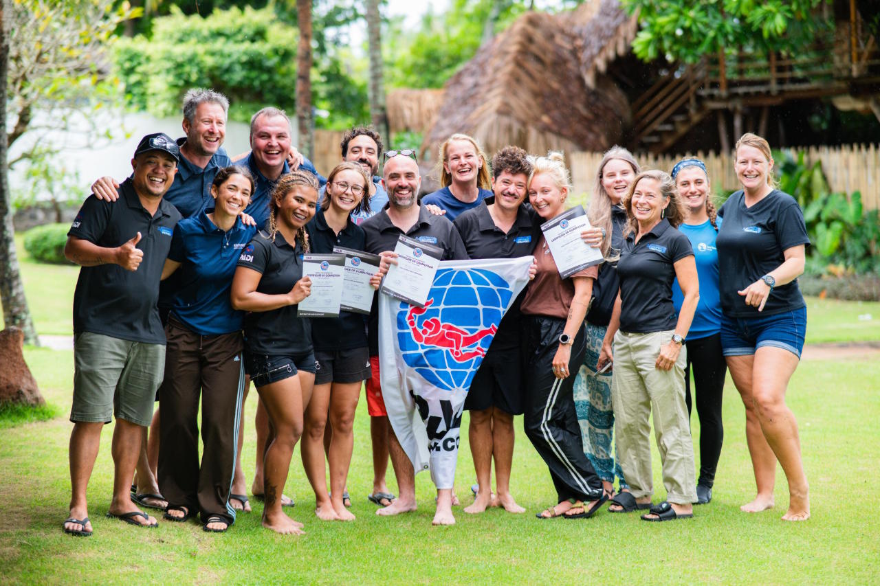 PADI Instructor Development Course students holding certificates of completion with Berlinda at Atmosphere Resorts & Spa